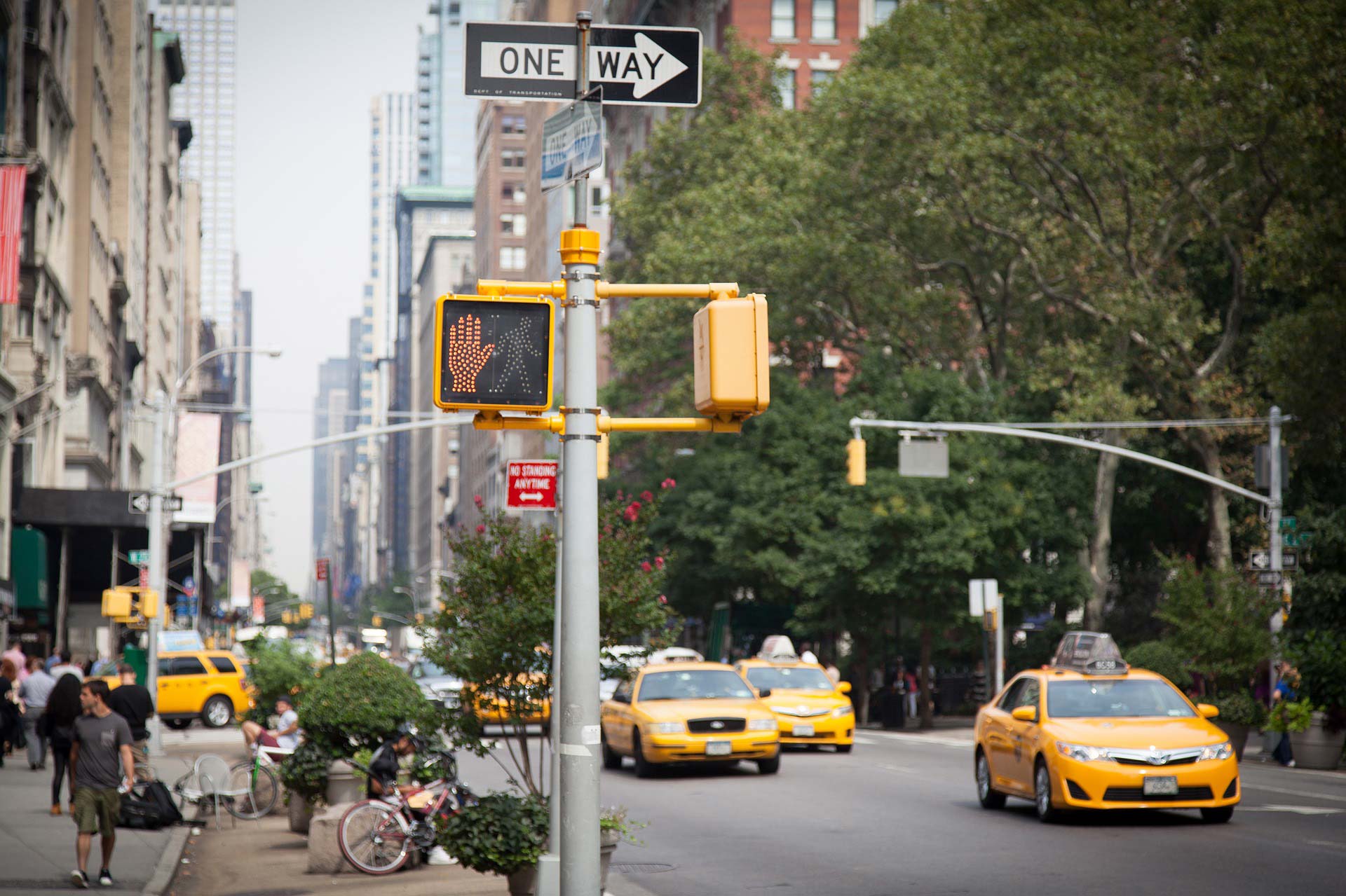 A busy street full of yellow taxi cabs